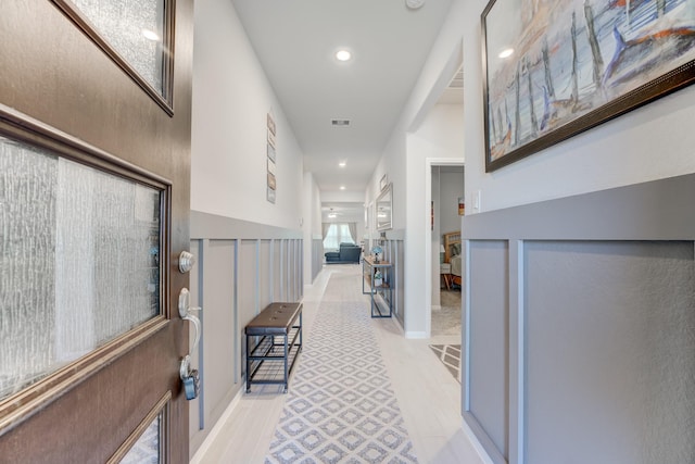 corridor with recessed lighting, visible vents, and light wood finished floors