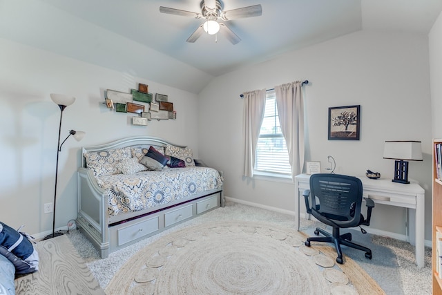 carpeted bedroom with vaulted ceiling, baseboards, and ceiling fan