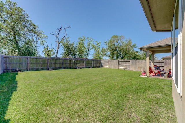 view of yard with a fenced backyard and a patio