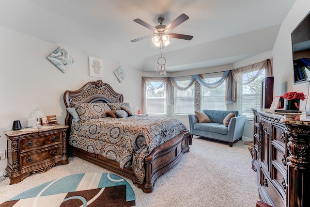 bedroom with a ceiling fan, light colored carpet, and multiple windows