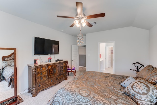 bedroom featuring vaulted ceiling, ensuite bathroom, ceiling fan, light carpet, and visible vents