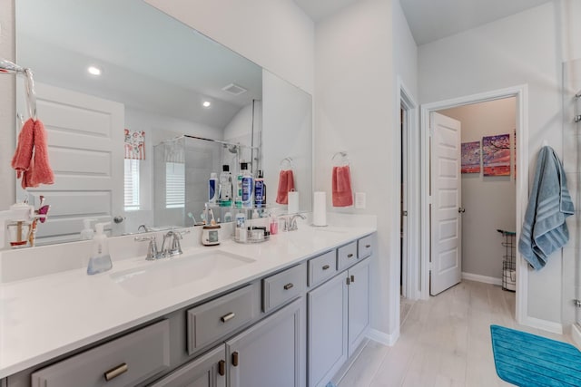 bathroom featuring a sink, double vanity, a stall shower, visible vents, and recessed lighting