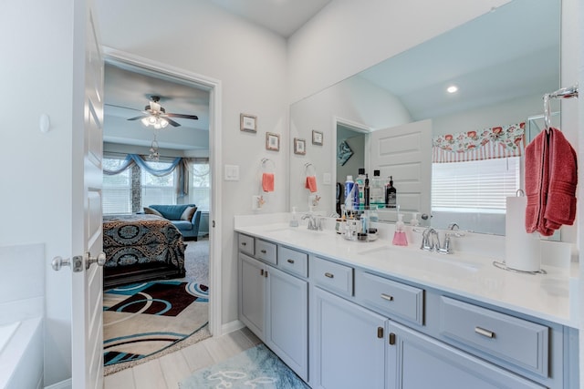 ensuite bathroom featuring double vanity, ensuite bathroom, a sink, and ceiling fan
