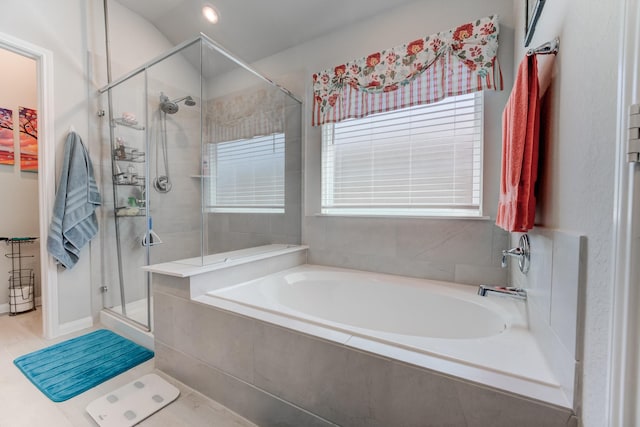 bathroom with a garden tub and a stall shower