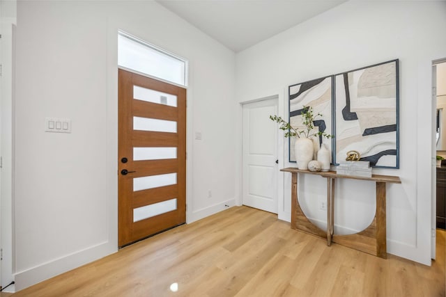 entryway with light wood-style floors and baseboards