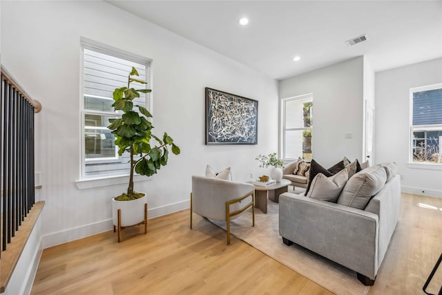 living room with visible vents, recessed lighting, light wood-style floors, and baseboards