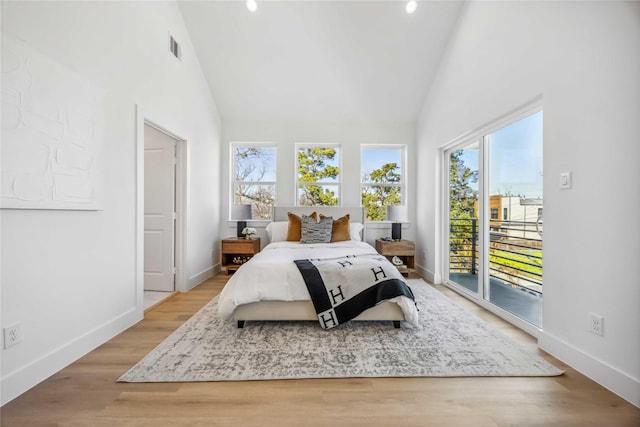 bedroom featuring high vaulted ceiling, access to outside, baseboards, and visible vents