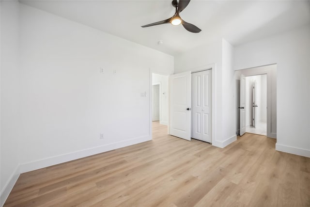 unfurnished bedroom with a ceiling fan, baseboards, light wood-style flooring, and a closet