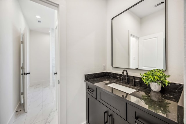 bathroom featuring visible vents, marble finish floor, baseboards, and vanity