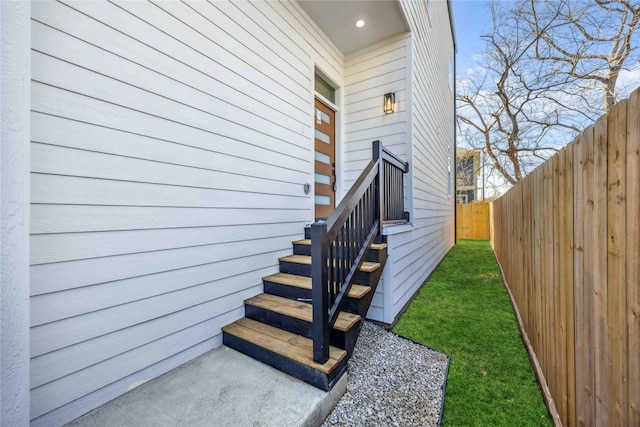 view of exterior entry with fence