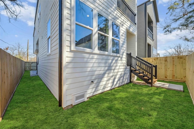 view of home's exterior with a yard and a fenced backyard