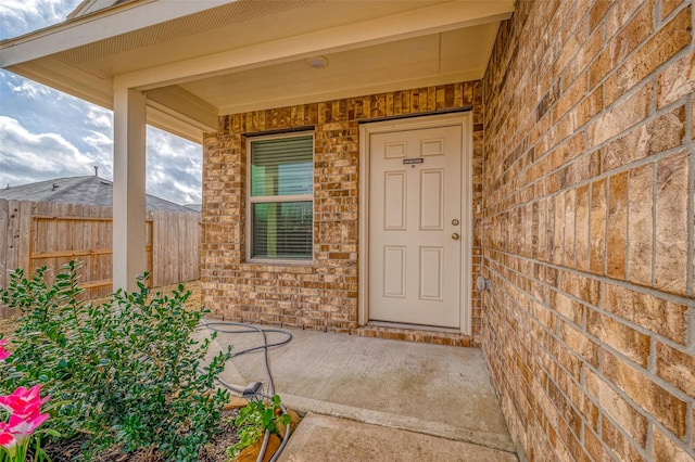 24119 Maple Turn Ln, Hockley, TX 77447 - doorway to property with brick siding, fence, and covered porch