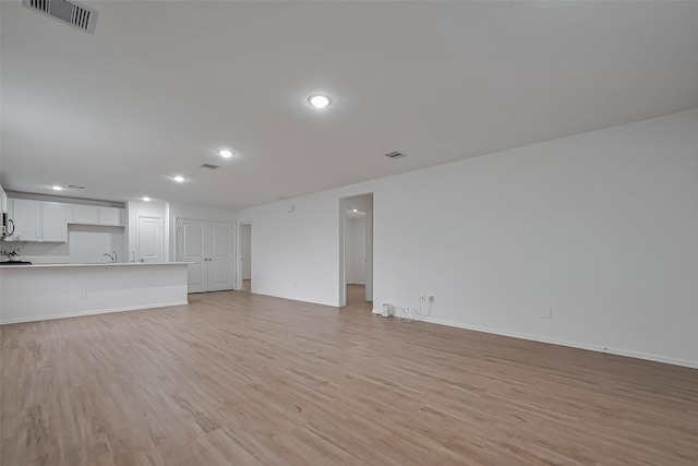 24119 Maple Turn Ln, Hockley, TX 77447 - unfurnished living room with recessed lighting, light wood-type flooring, visible vents, and baseboards
