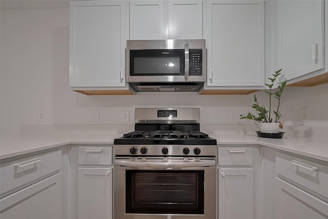 24119 Maple Turn Ln, Hockley, TX 77447 - kitchen featuring white cabinets, appliances with stainless steel finishes, and light countertops