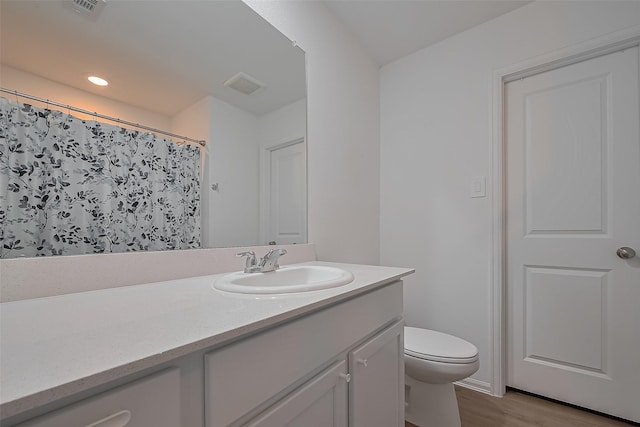 24119 Maple Turn Ln, Hockley, TX 77447 - bathroom featuring toilet, vanity, wood finished floors, and visible vents
