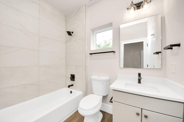 783 Mansfield St, Houston, TX 77091 - bathroom featuring wood finished floors, toilet, vanity, baseboards, and bathtub / shower combination