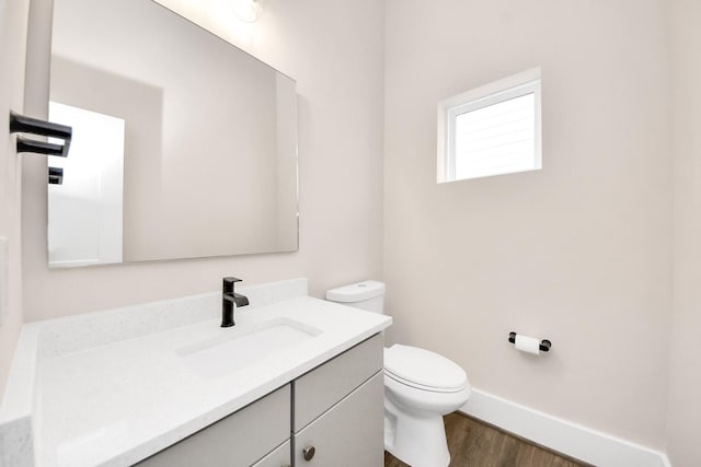 783 Mansfield St, Houston, TX 77091 - bathroom with baseboards, wood finished floors, vanity, and toilet