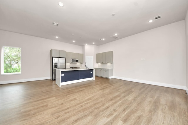 783 Mansfield St, Houston, TX 77091 - unfurnished living room with light wood-style floors, visible vents, and recessed lighting