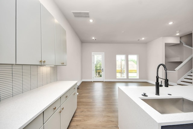 783 Mansfield St, Houston, TX 77091 - kitchen with light countertops, visible vents, a sink, and tasteful backsplash