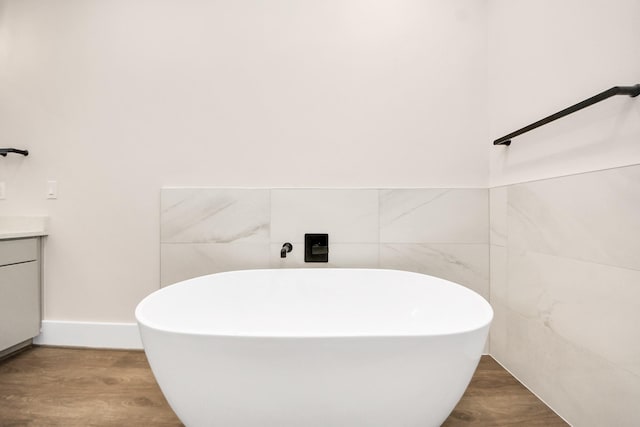 783 Mansfield St, Houston, TX 77091 - full bath featuring a freestanding bath, vanity, wood finished floors, and tile walls