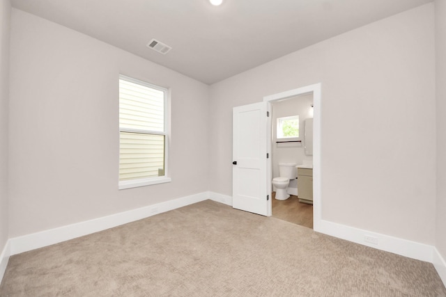 783 Mansfield St, Houston, TX 77091 - unfurnished bedroom featuring carpet flooring, baseboards, visible vents, and ensuite bath