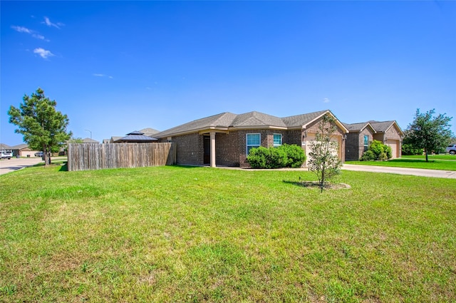 single story home featuring fence, an attached garage, a front lawn, and driveway