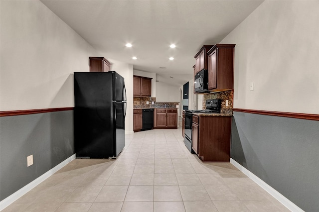 kitchen featuring dark stone countertops, black appliances, decorative backsplash, light tile patterned floors, and recessed lighting