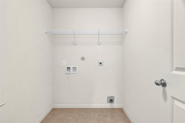 clothes washing area with laundry area, hookup for an electric dryer, light tile patterned flooring, hookup for a washing machine, and baseboards