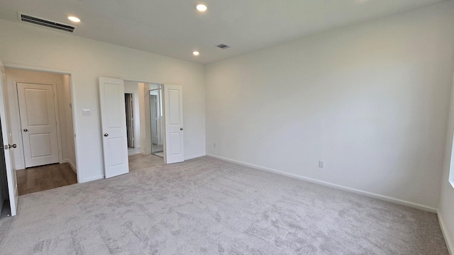 unfurnished bedroom featuring visible vents, carpet flooring, and baseboards