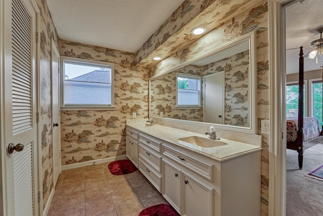 11831 Thoreau Dr, Montgomery, TX 77356 - full bath featuring a sink, double vanity, ensuite bathroom, baseboards, and wallpapered walls