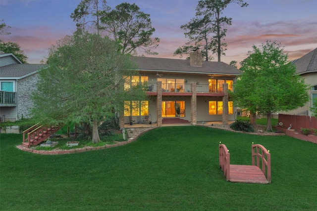 11831 Thoreau Dr, Montgomery, TX 77356 - back of house featuring a ceiling fan, a chimney, stairs, a yard, and a patio