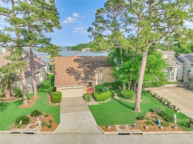 11831 Thoreau Dr, Montgomery, TX 77356 - view of front of house featuring a front lawn, driveway, a water view, and an attached garage