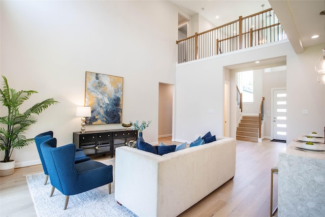 1114 Niagara St, Houston, TX 77051 - living area featuring wood finished floors, a high ceiling, baseboards, and stairway