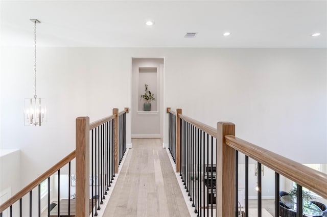 1114 Niagara St, Houston, TX 77051 - hallway featuring a notable chandelier, an upstairs landing, light wood finished floors, and recessed lighting