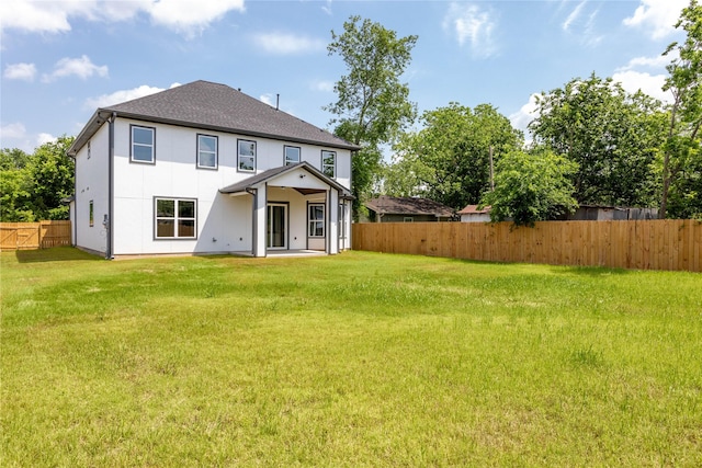 1114 Niagara St, Houston, TX 77051 - rear view of property featuring stucco siding, a yard, a patio, and a fenced backyard