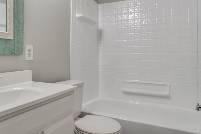 bathroom featuring toilet, vanity, and tub / shower combination