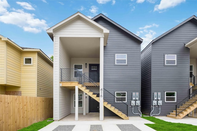 back of house featuring a patio area, stairway, and fence