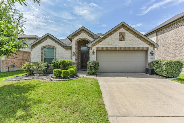 3754 Paladera Place Ct, Spring, TX 77386 - french country home with stone siding, a garage, driveway, and a front yard