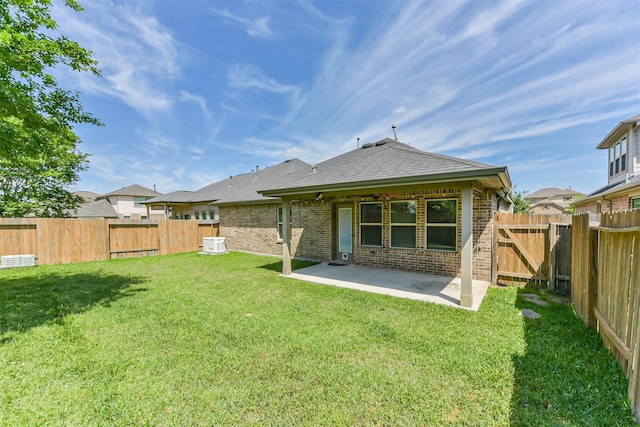 3754 Paladera Place Ct, Spring, TX 77386 - back of property featuring brick siding, a fenced backyard, a lawn, and a patio area