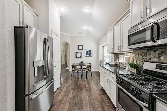 3754 Paladera Place Ct, Spring, TX 77386 - kitchen featuring vaulted ceiling, crown molding, arched walkways, dark wood-style floors, and appliances with stainless steel finishes