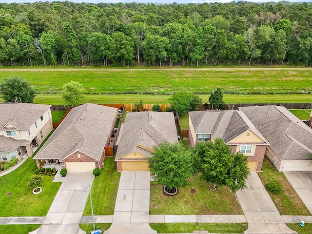 birds eye view of property with a view of trees and a residential view