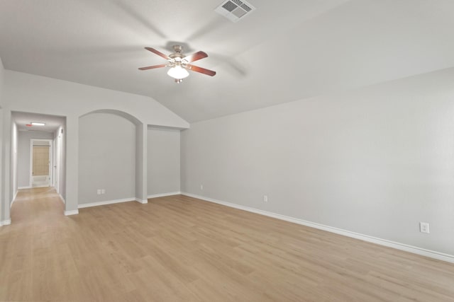 unfurnished living room with visible vents, baseboards, light wood-type flooring, a ceiling fan, and vaulted ceiling
