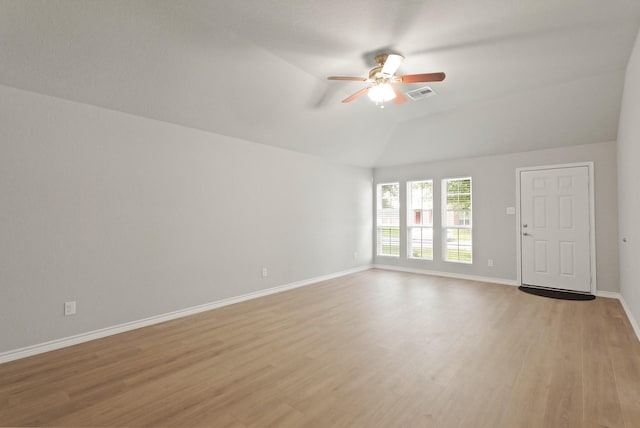 unfurnished living room with ceiling fan, baseboards, lofted ceiling, light wood-type flooring, and visible vents