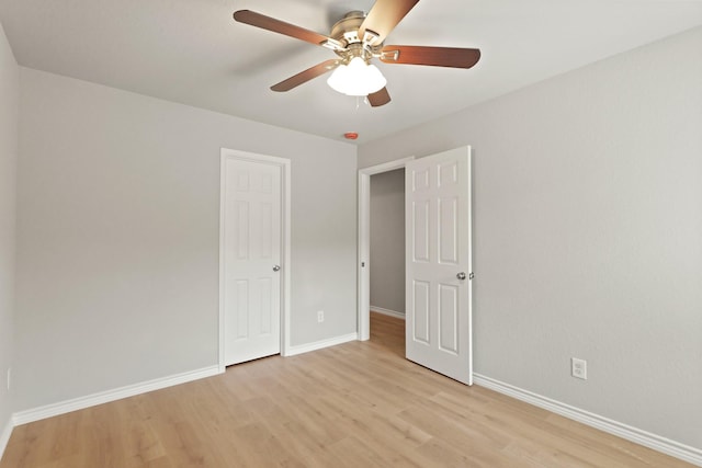 unfurnished bedroom with baseboards, light wood-style flooring, and ceiling fan