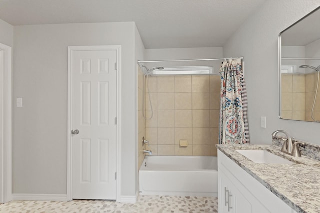 full bathroom featuring shower / bath combo with shower curtain and vanity