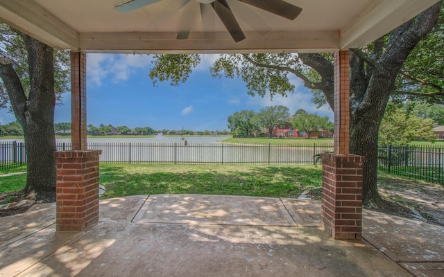 view of patio featuring a fenced backyard, a water view, and ceiling fan