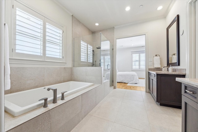 bathroom with crown molding, tile patterned floors, a bath, vanity, and walk in shower