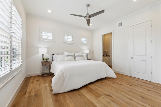 bedroom with crown molding, light wood-type flooring, baseboards, visible vents, and recessed lighting