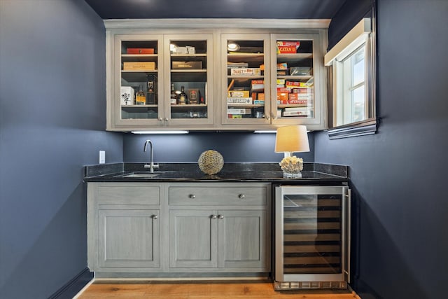 bar with wet bar, a sink, and wine cooler