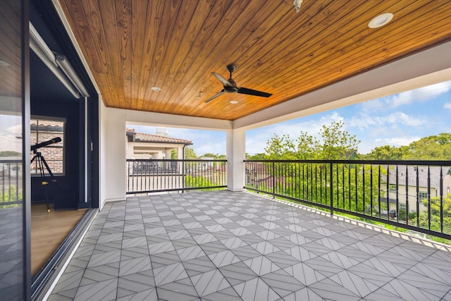 view of patio / terrace with a ceiling fan and a balcony